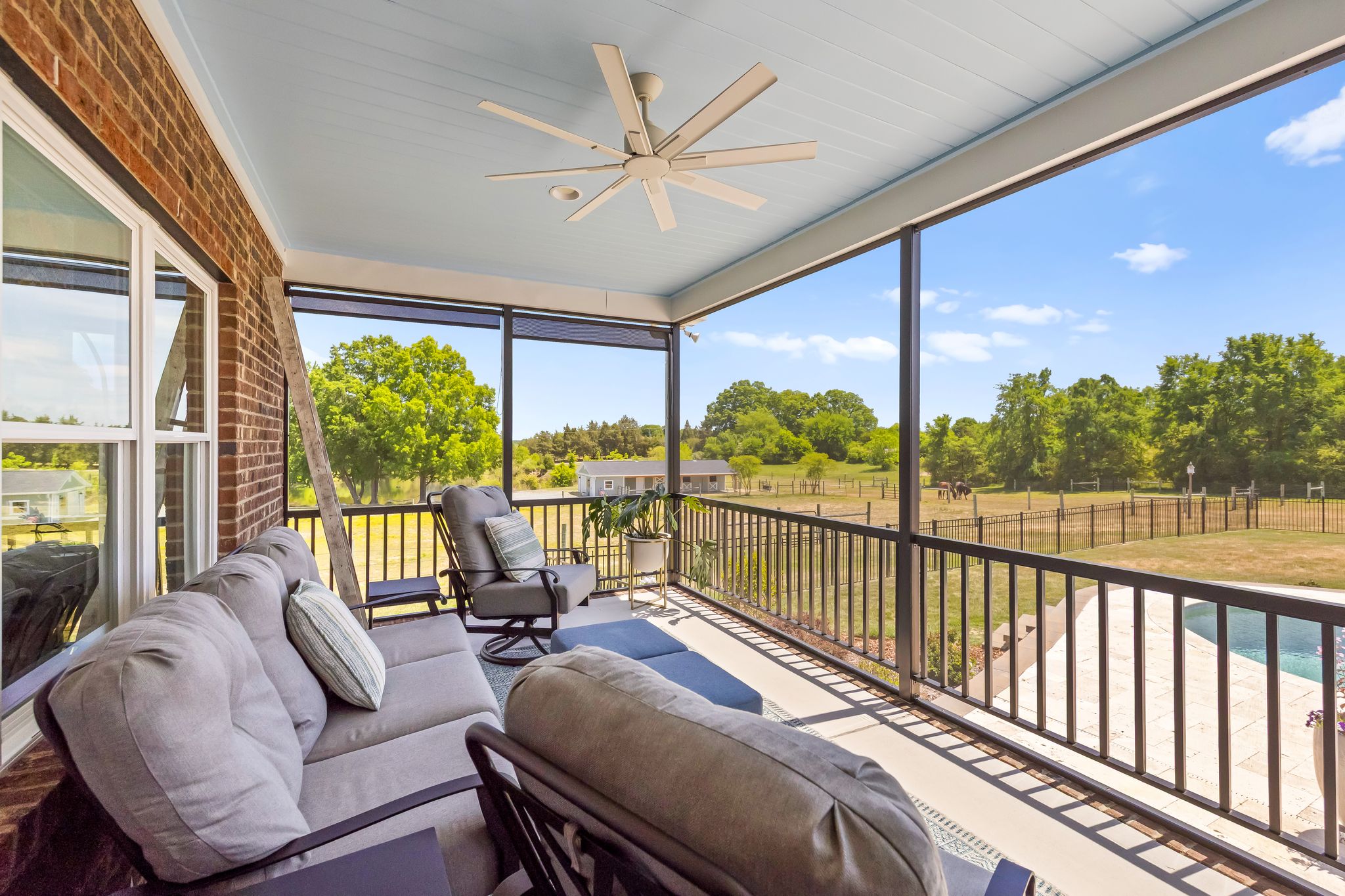 Screened porch overlooking pool and pastures
