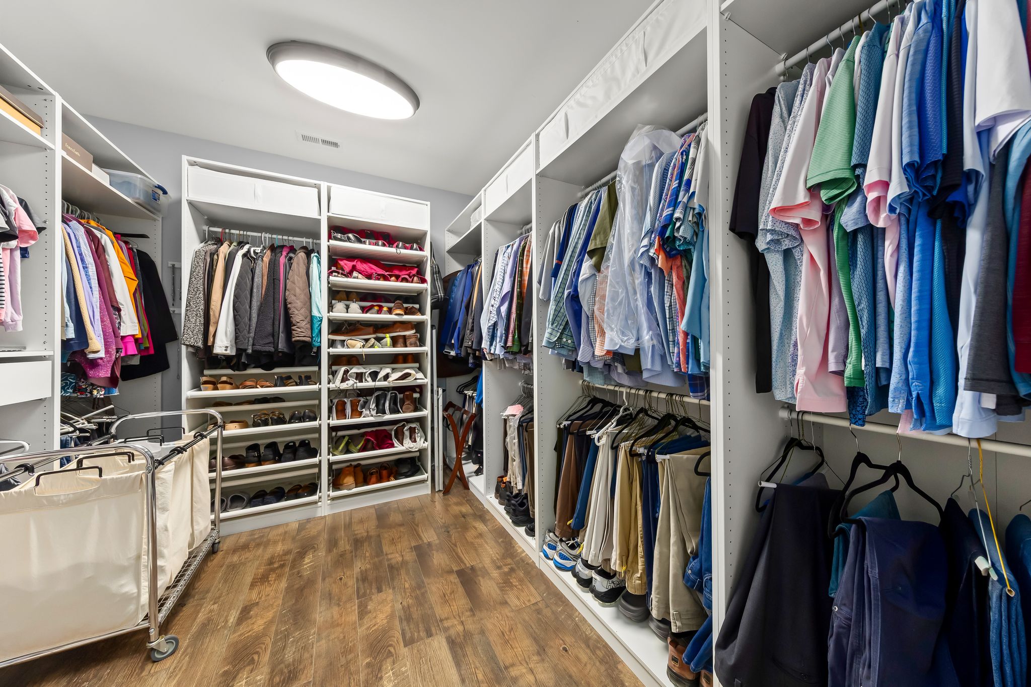 Walk-in primary closet with custom built-ins
