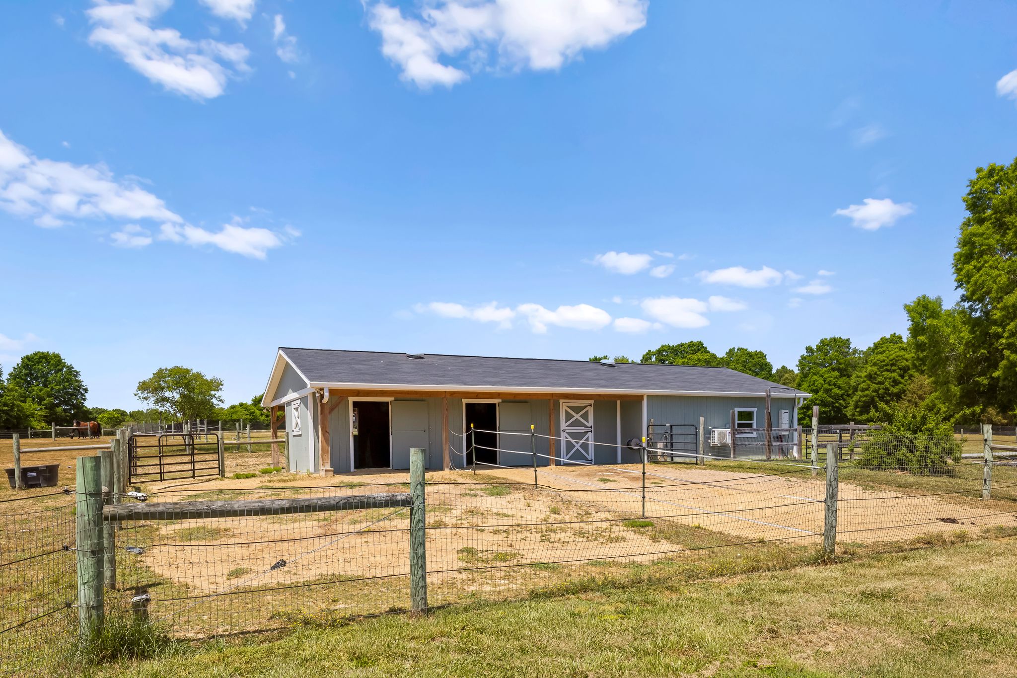 Three-stall horse barn with paddocks